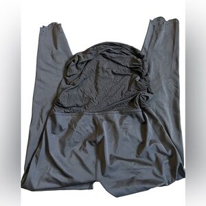 Silky matte black spandex footless maternity leggings detail design at ankles